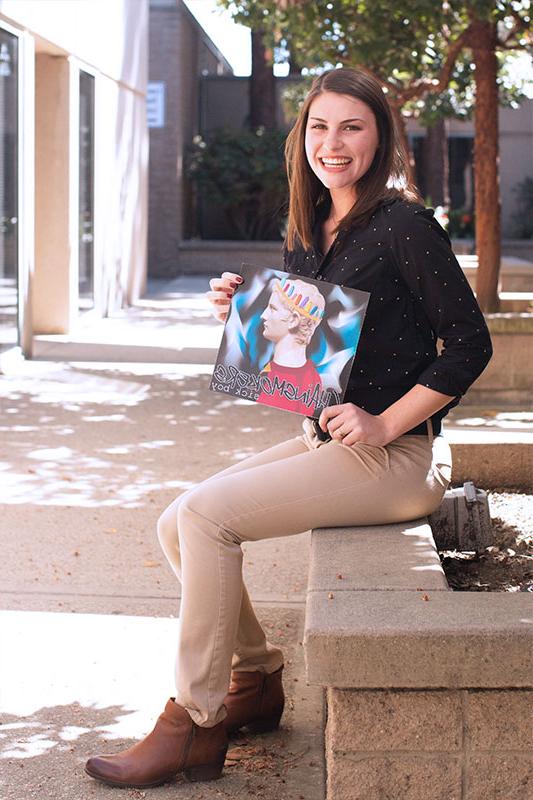 Susan Eschelbach holding an album cover she designed